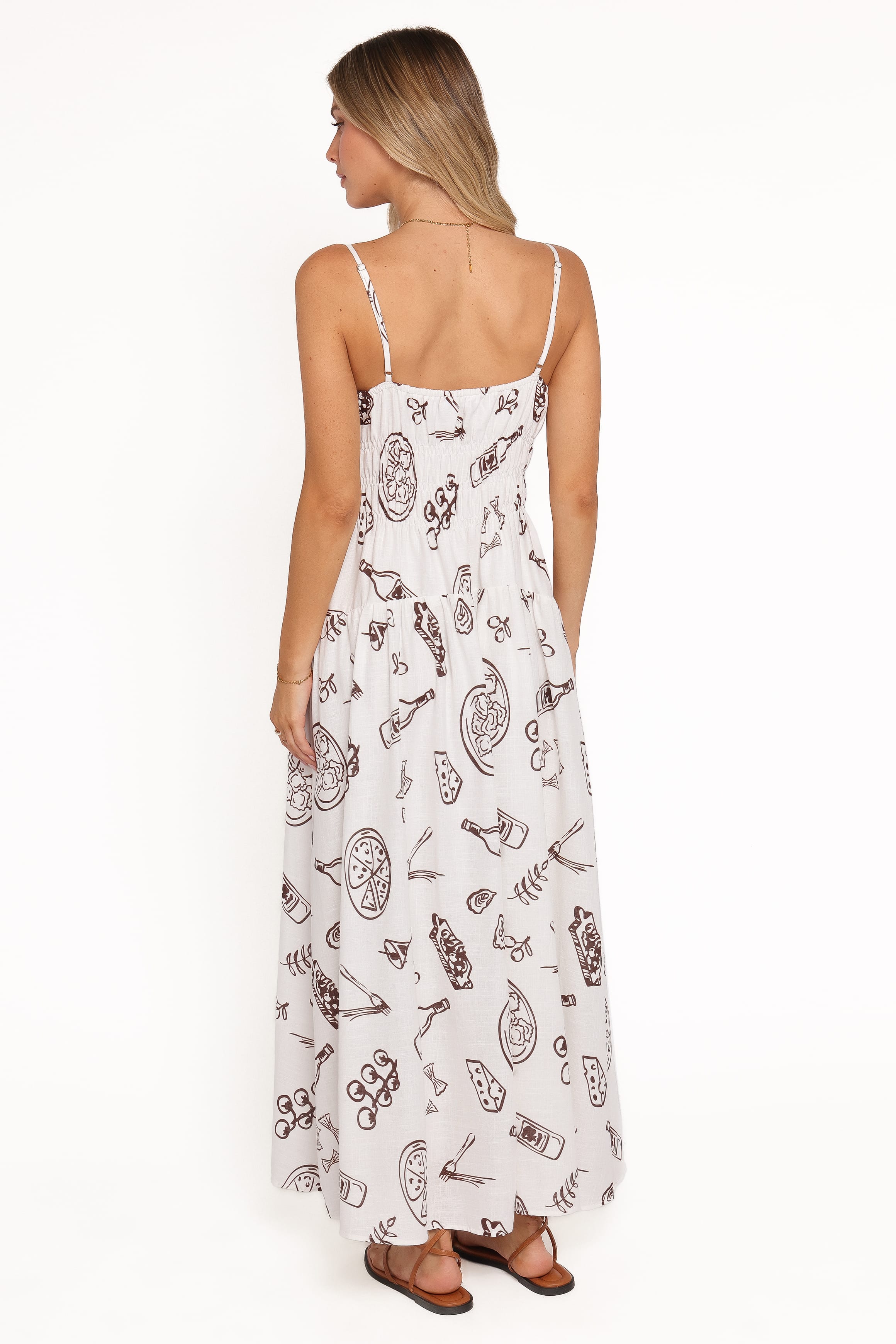 Woman wearing a white dress with black patterns on a white background