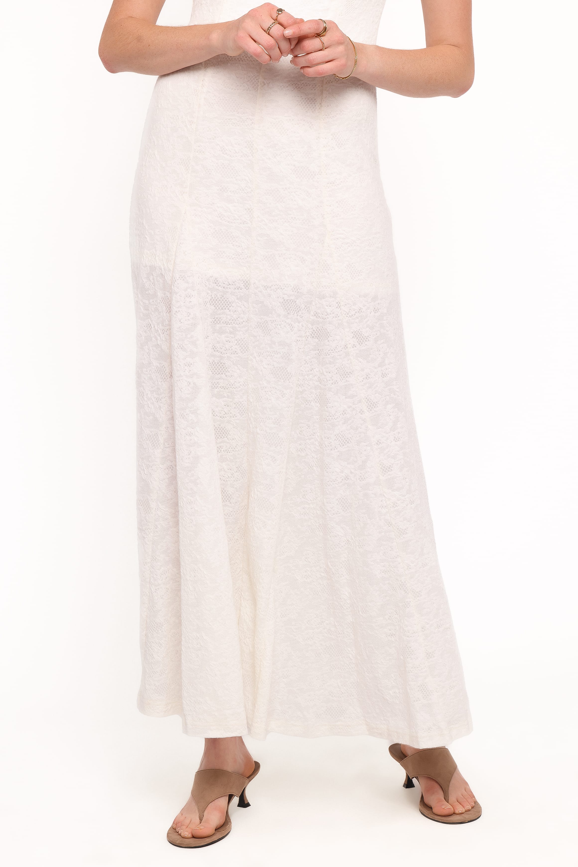 Person wearing a long white dress on a white background