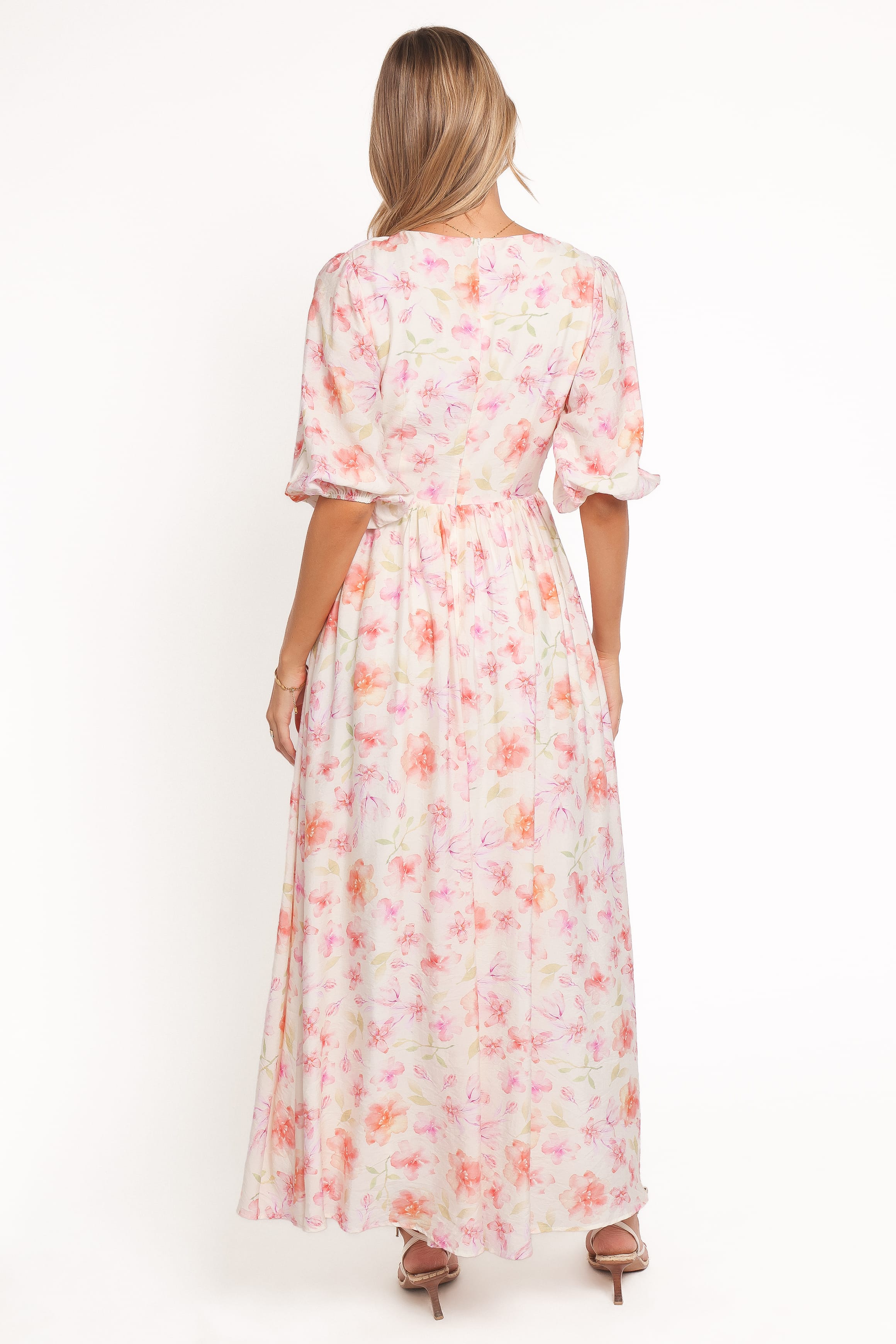 Woman wearing a floral dress on a white background
