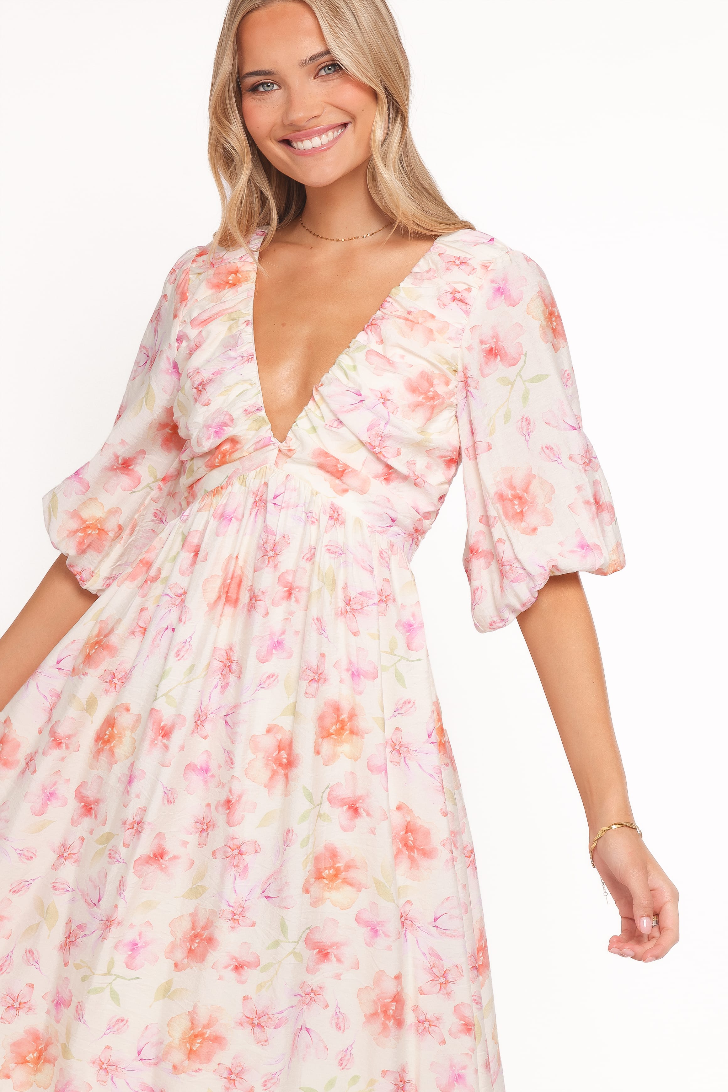 Woman wearing a floral dress with a plain background