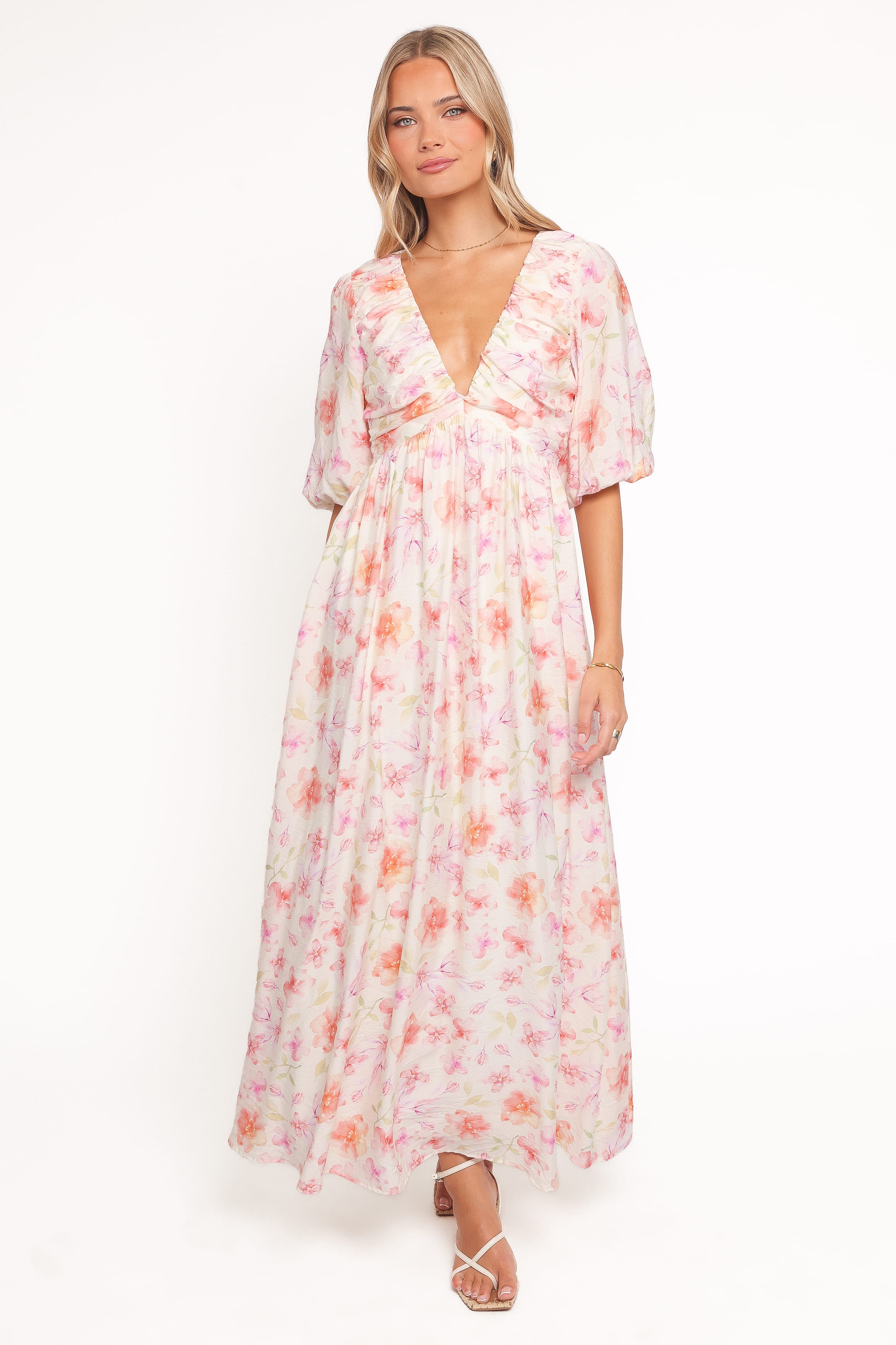 Woman wearing a floral dress on a white background