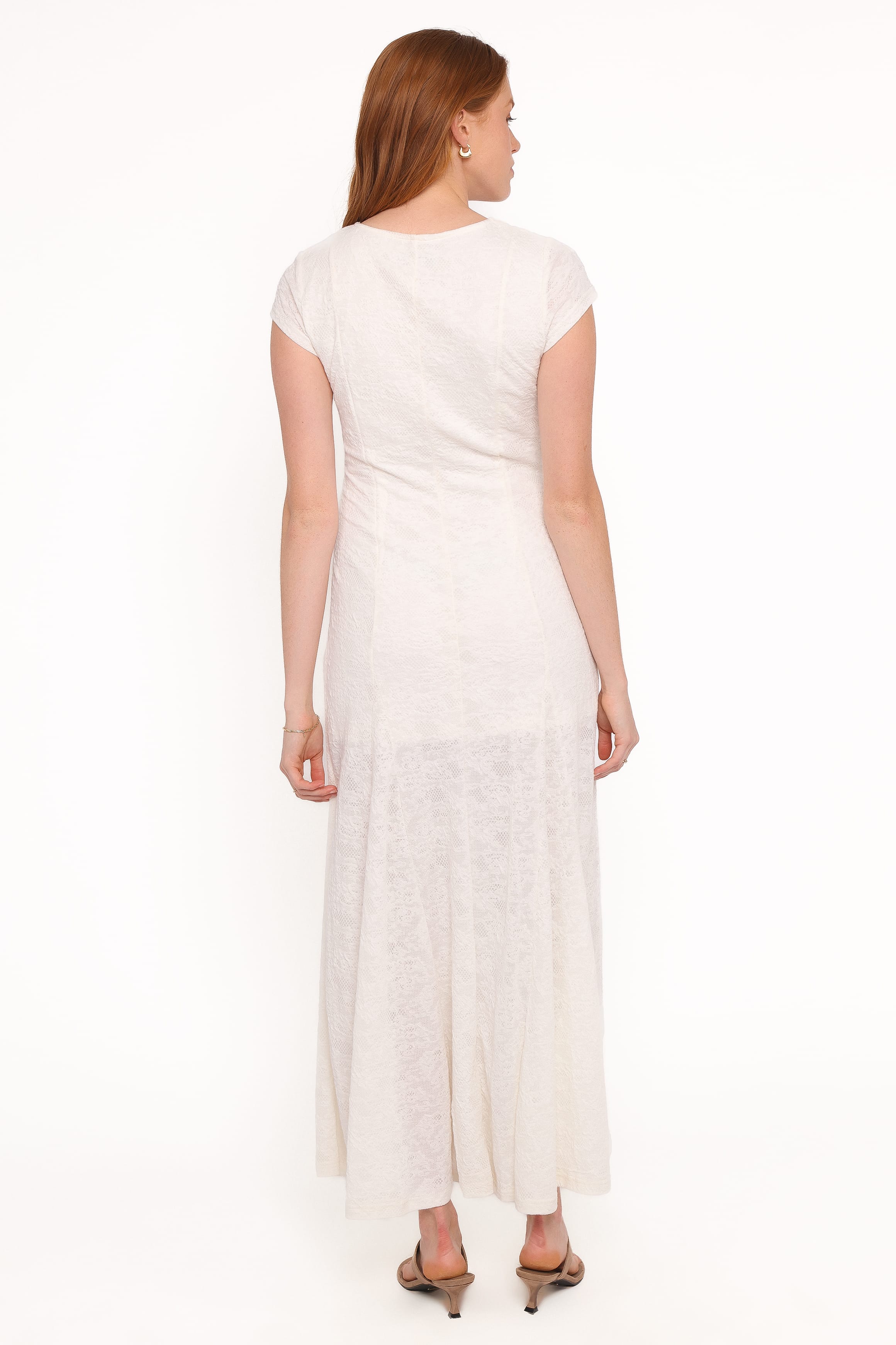 Woman wearing a white dress on a white background