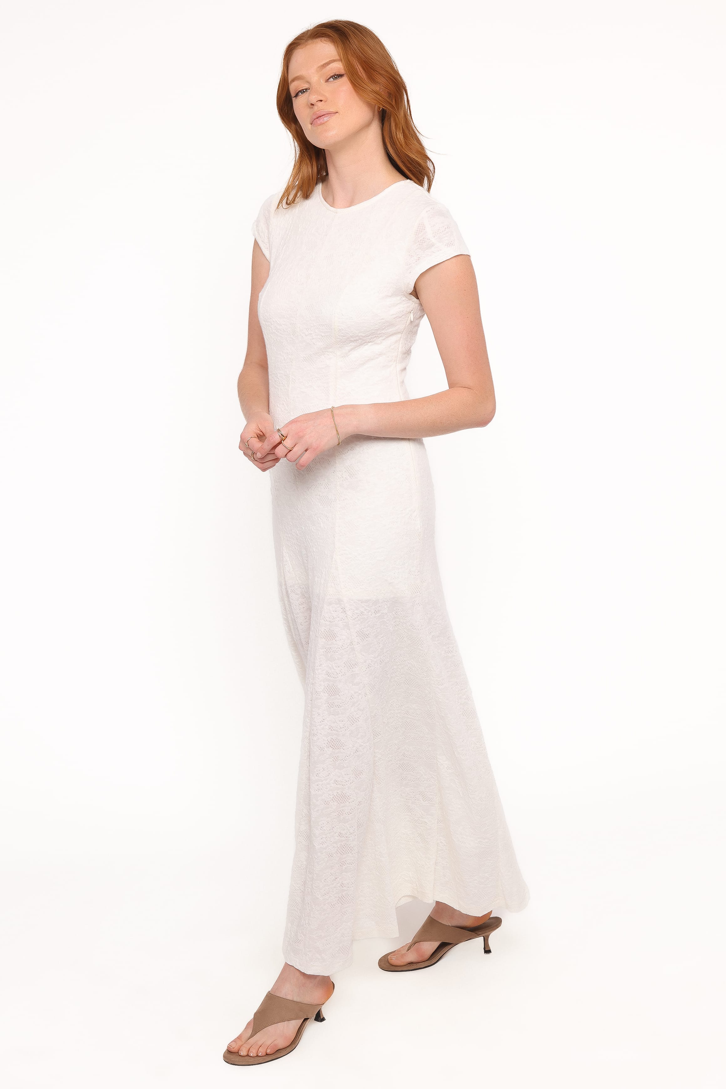 Woman wearing a white dress on a white background