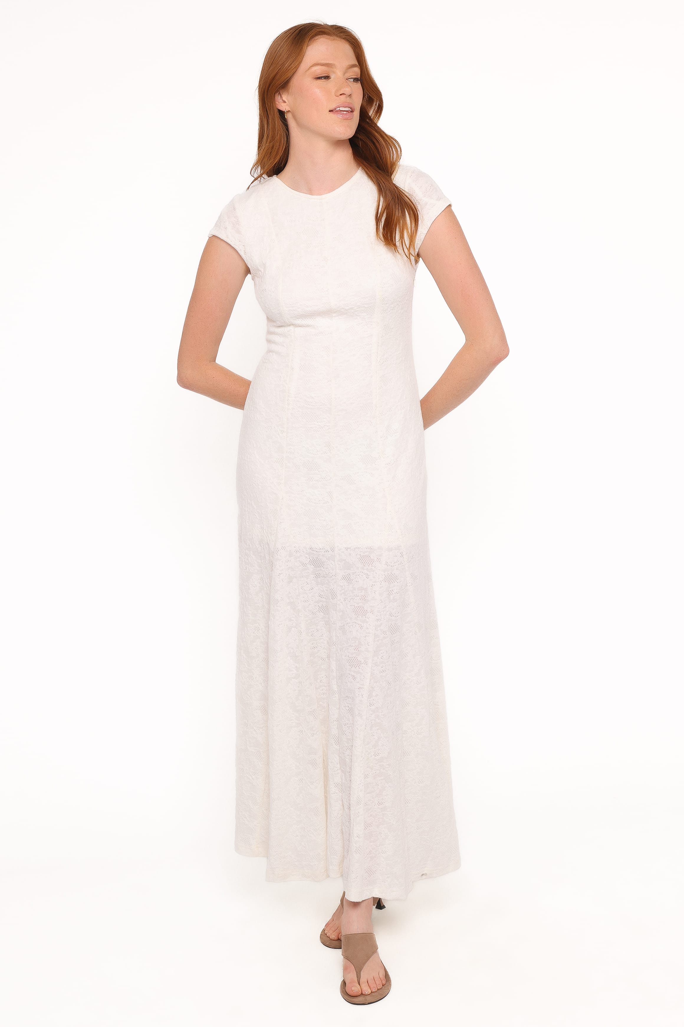 Woman wearing a white dress on a white background