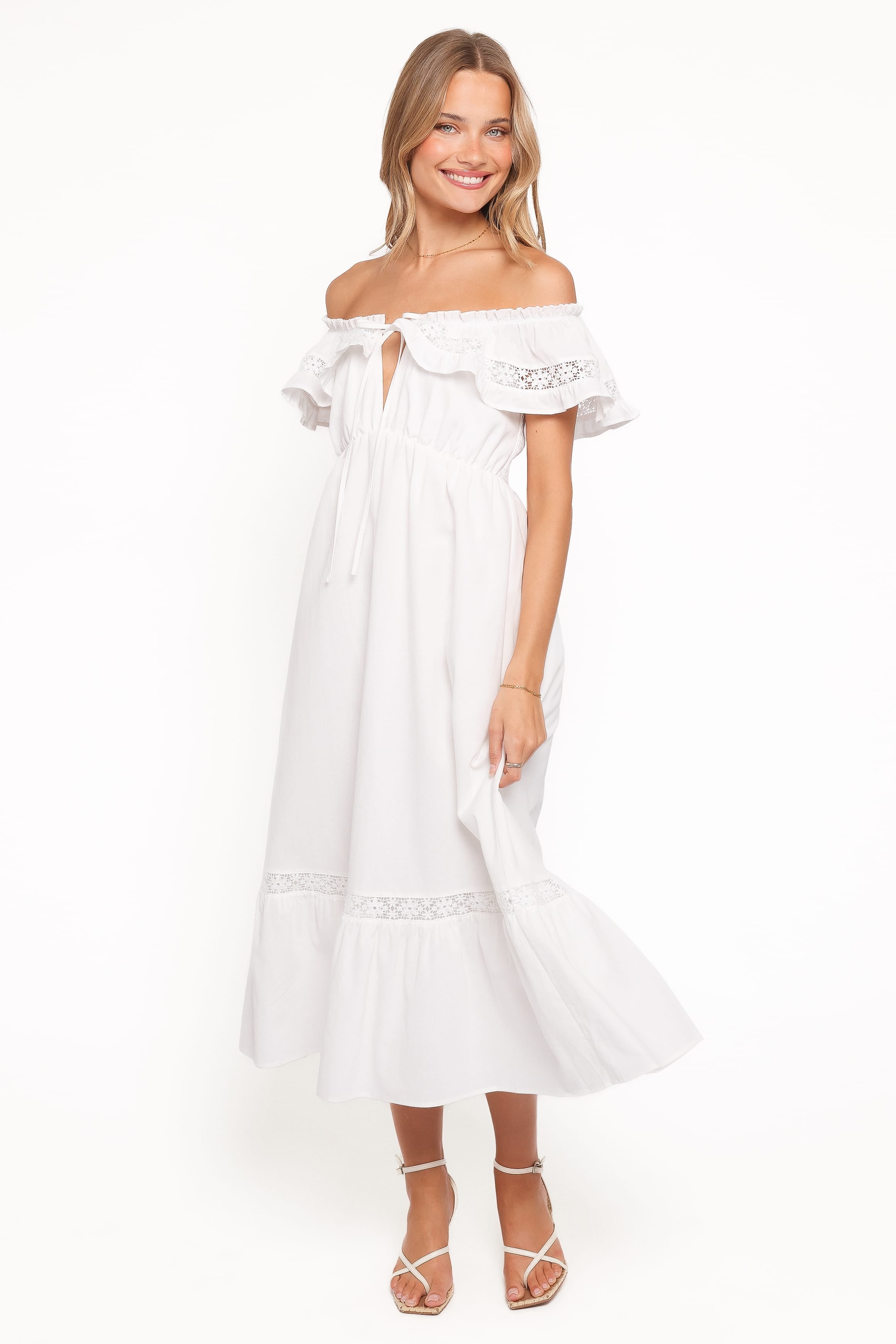 Woman wearing a white off-shoulder dress on a white background