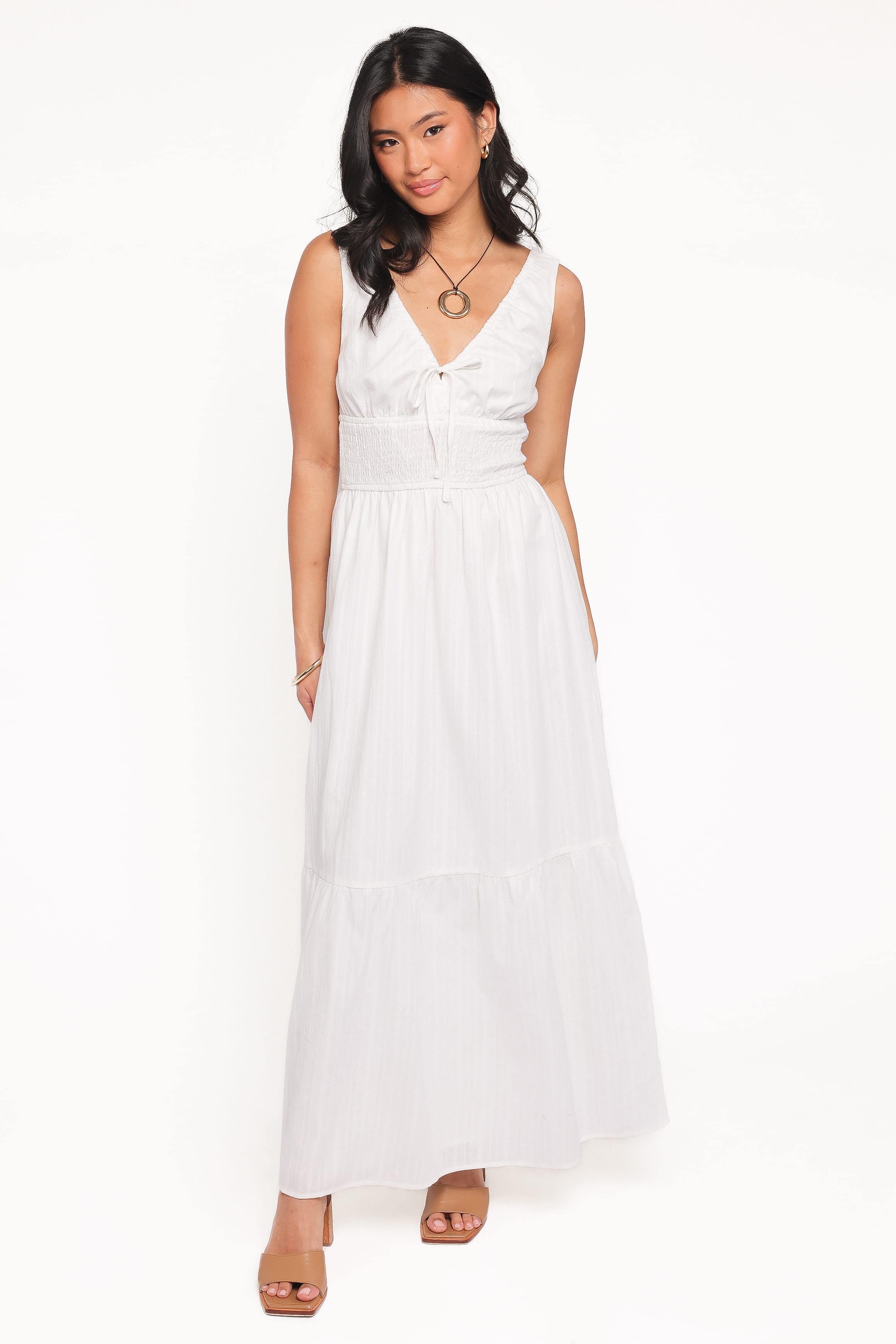 Woman wearing a white dress on a white background