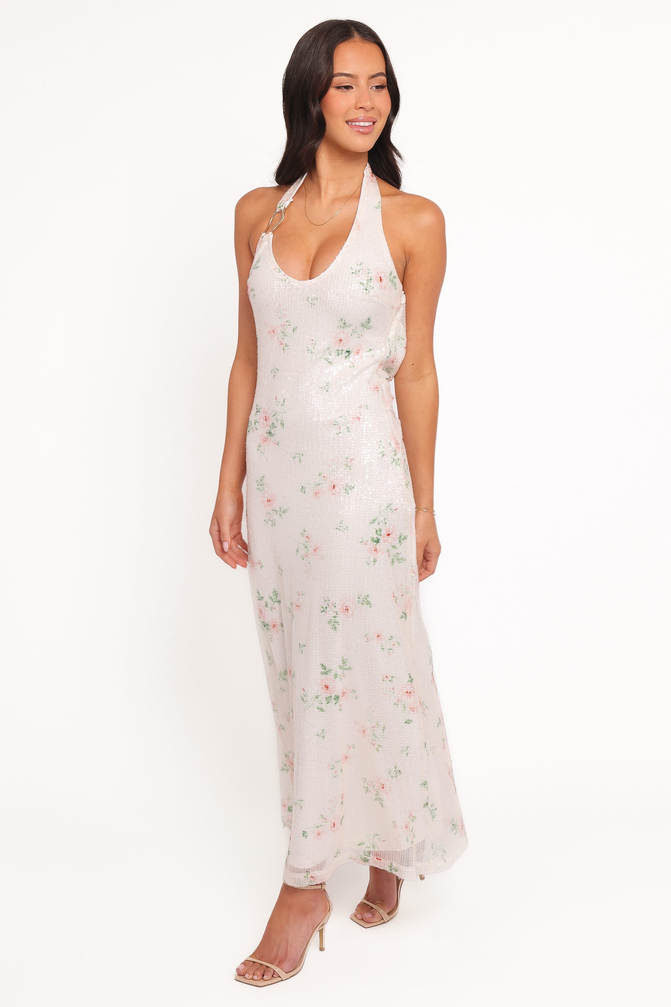 Woman wearing a white floral dress on a white background
