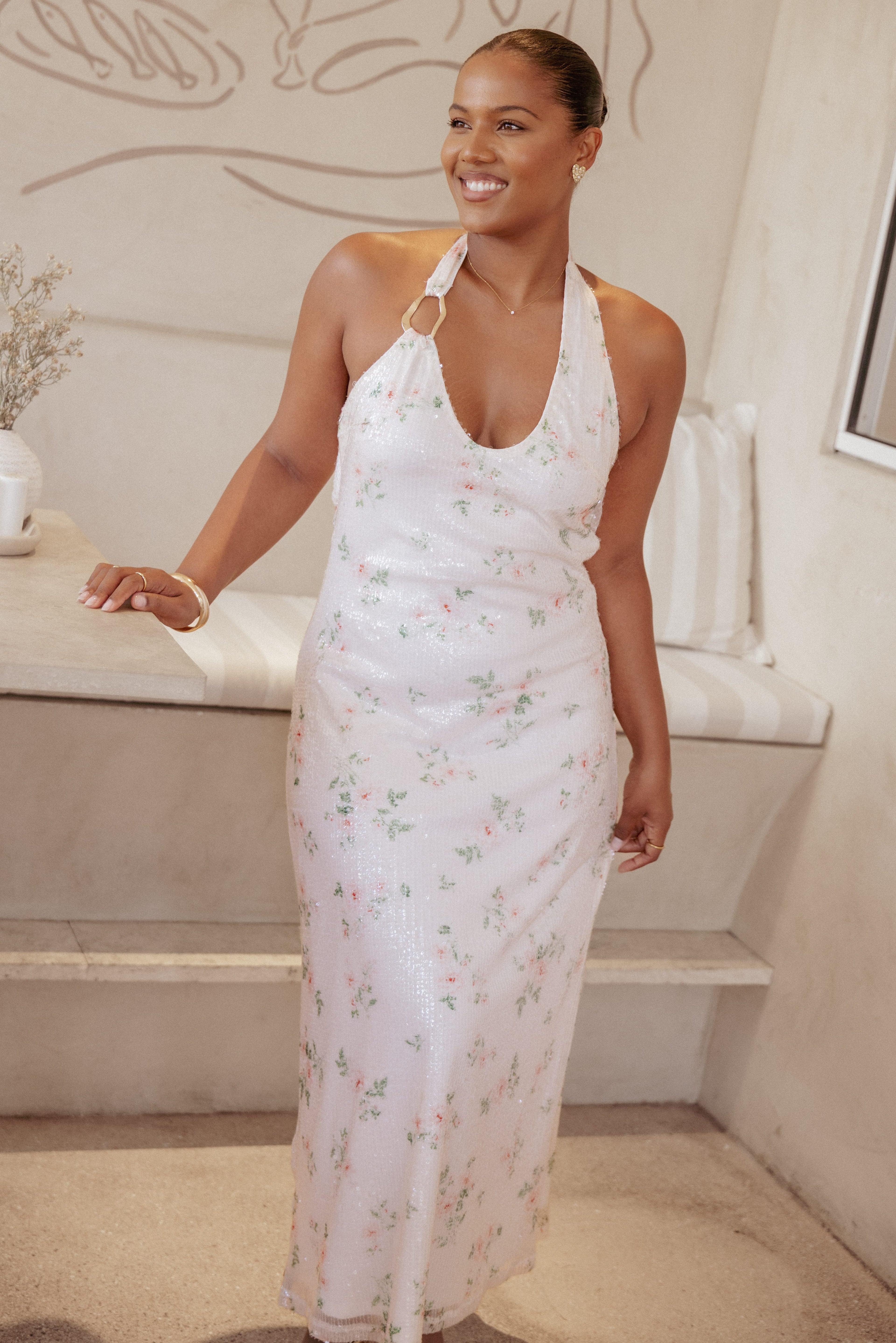 Woman wearing a floral dress in a home setting