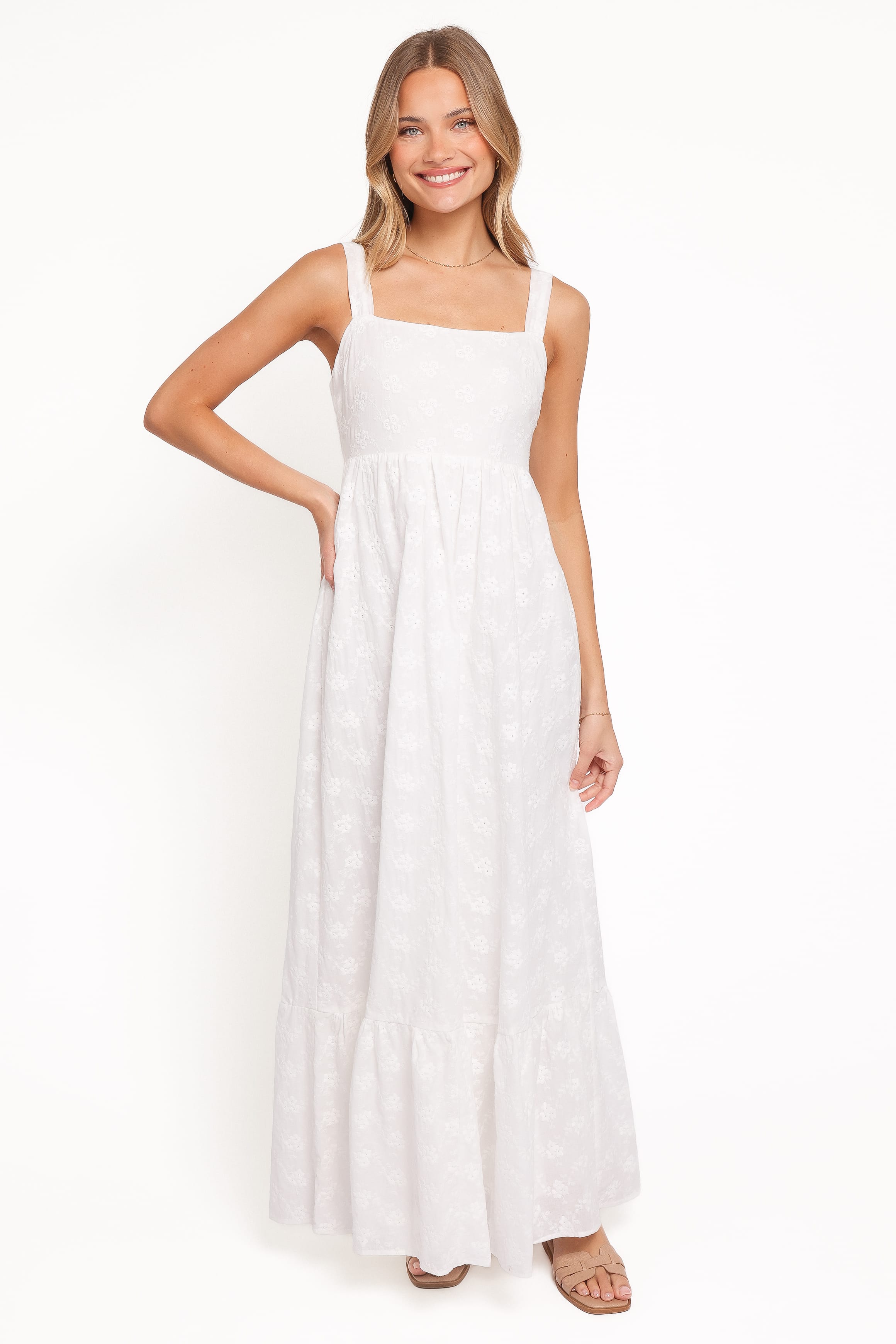 Woman wearing a white dress against a white background
