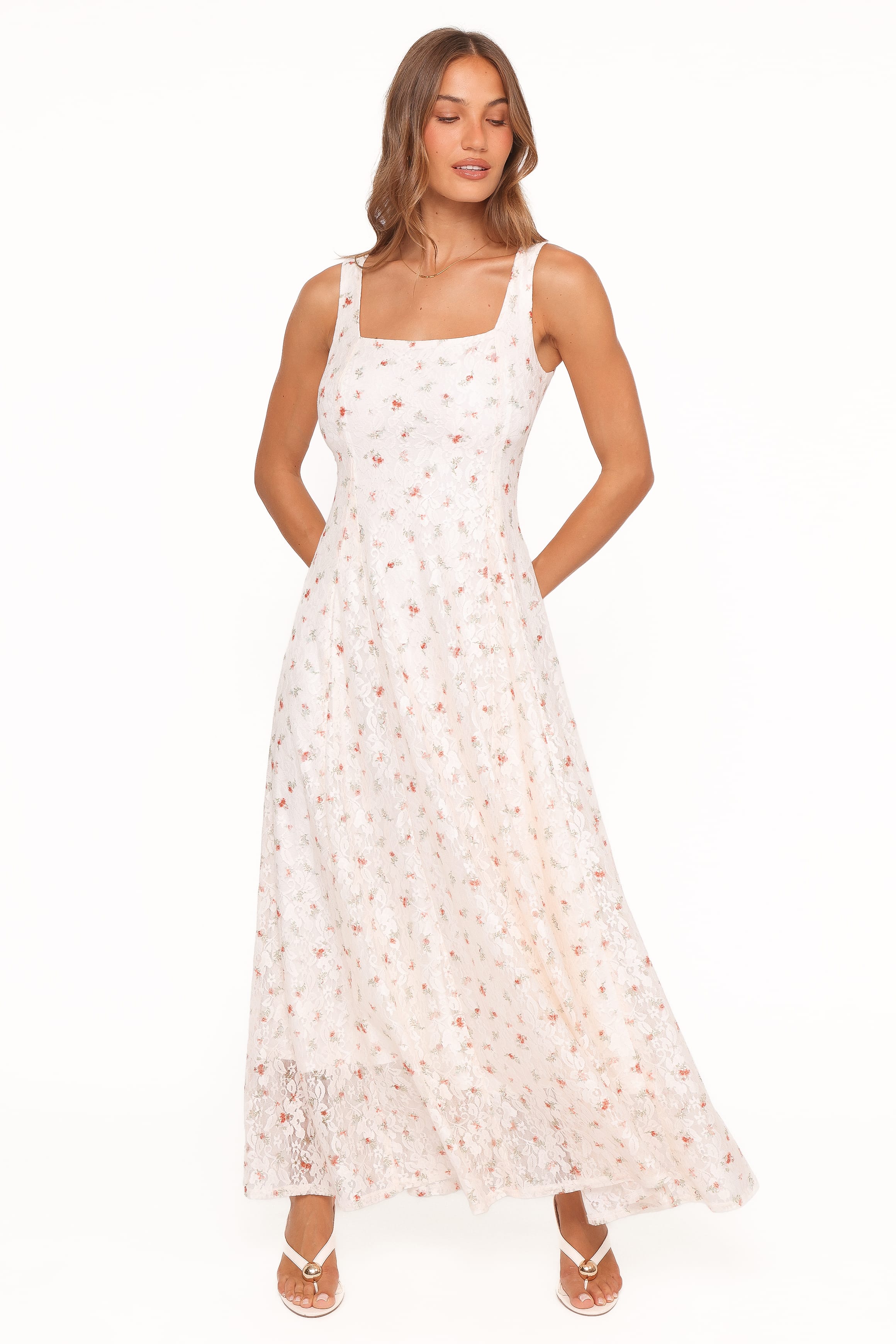 Woman wearing a white floral dress on a white background