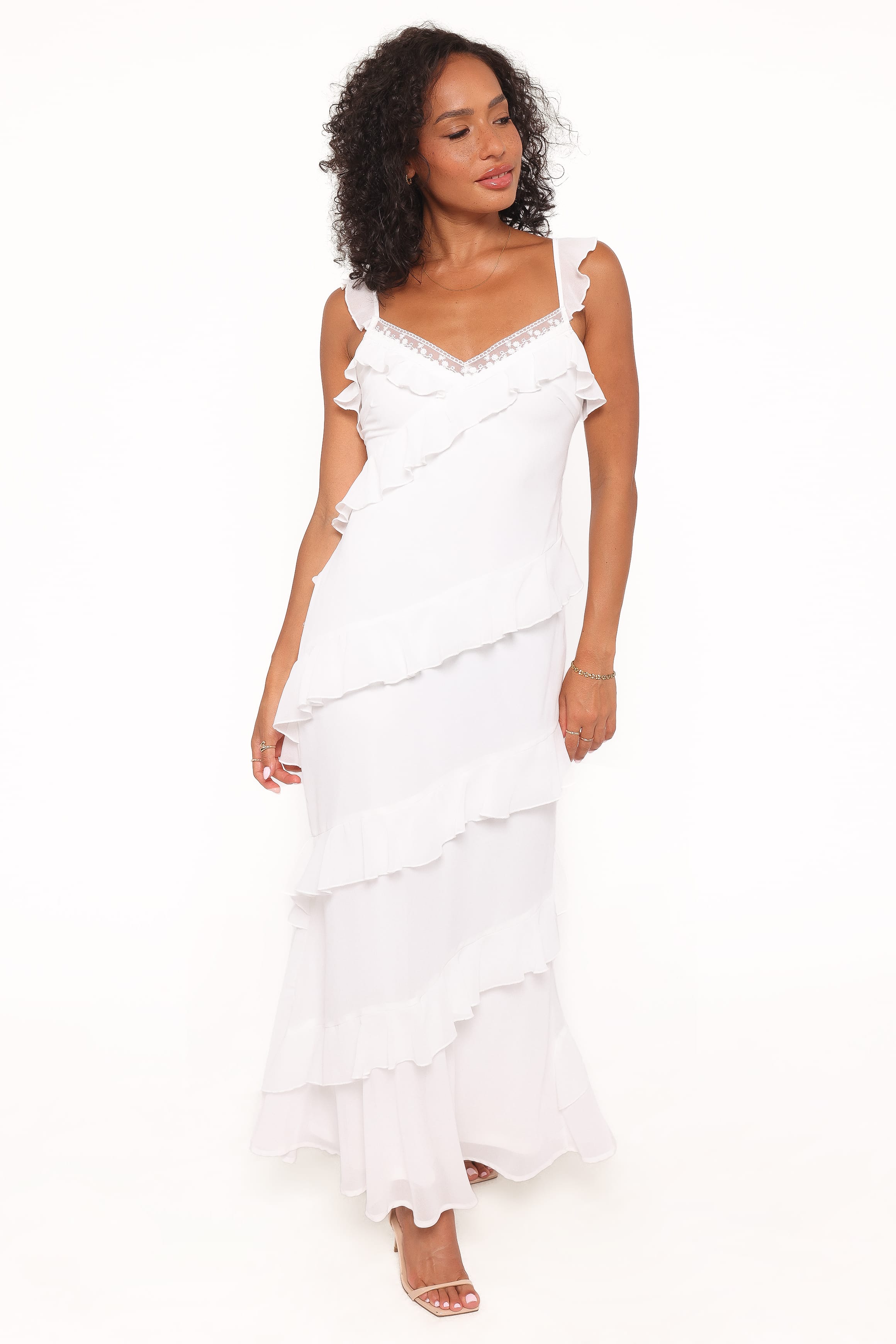 Woman wearing a white ruffled dress on a white background