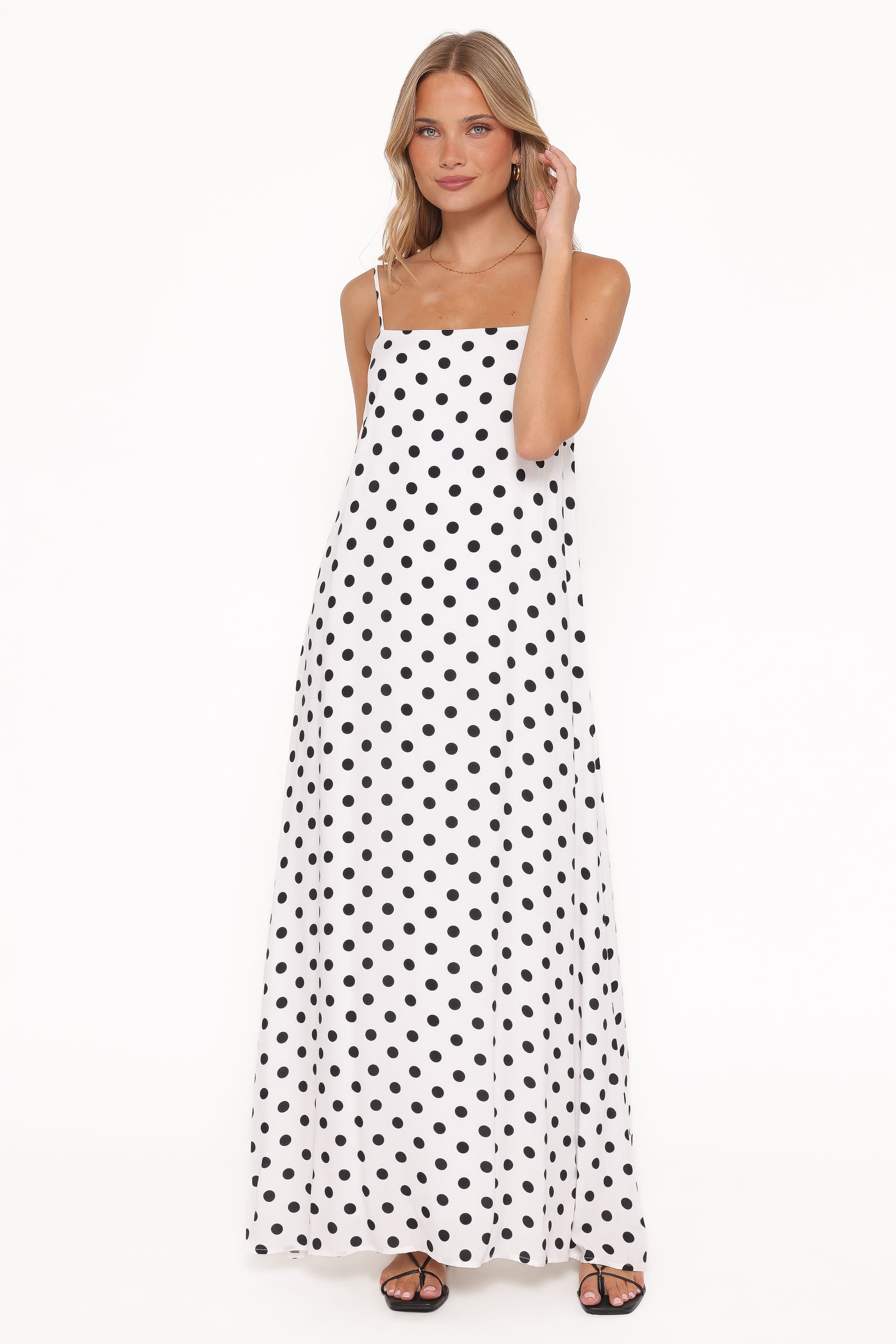 Woman wearing a polka dot dress on a white background