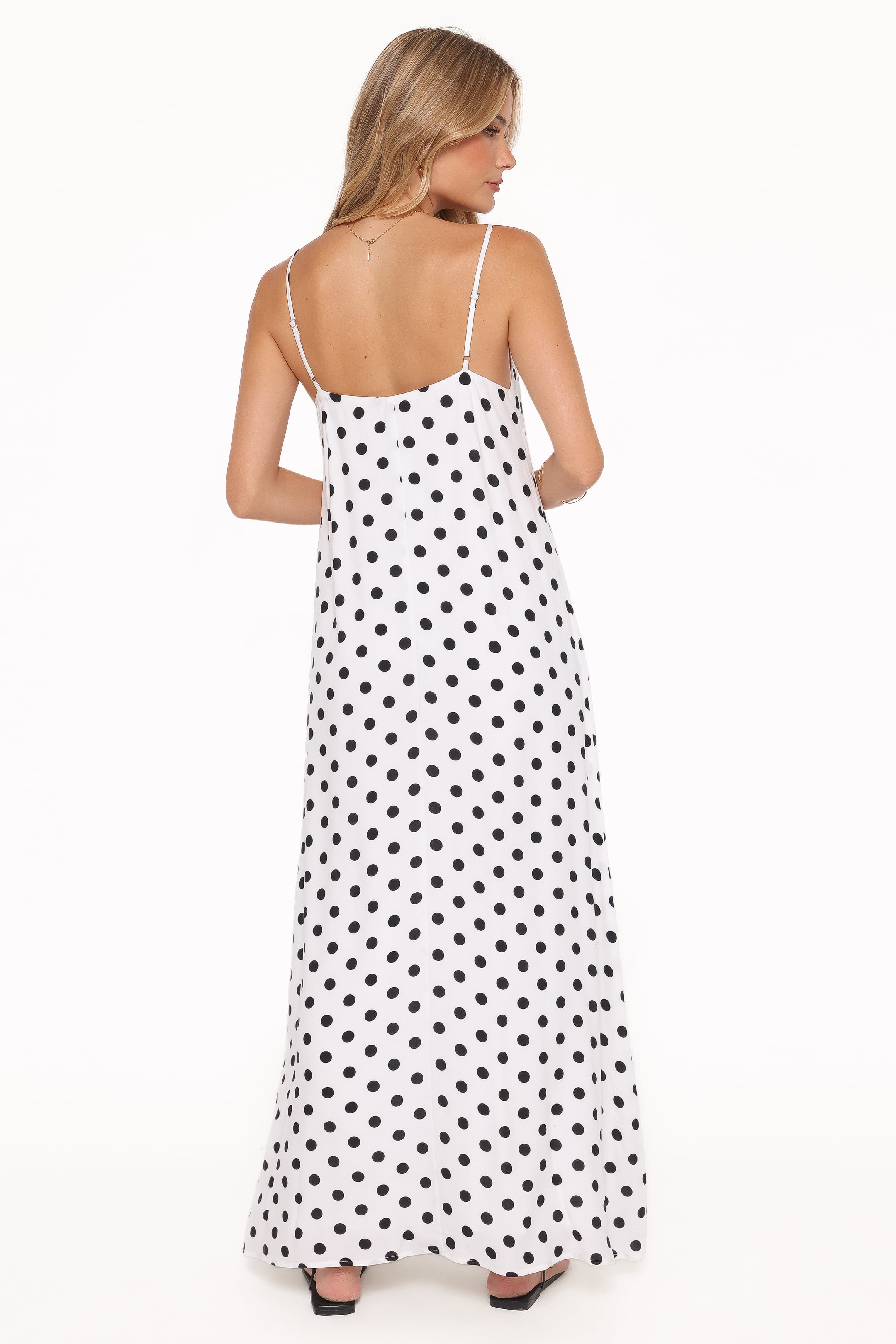 Woman wearing a polka dot dress on a white background
