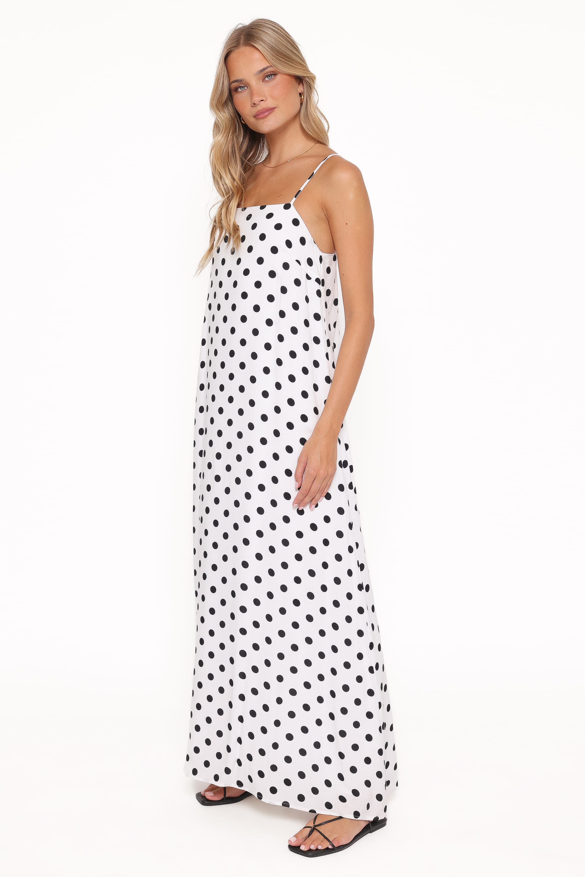 Woman wearing a polka dot dress on a white background