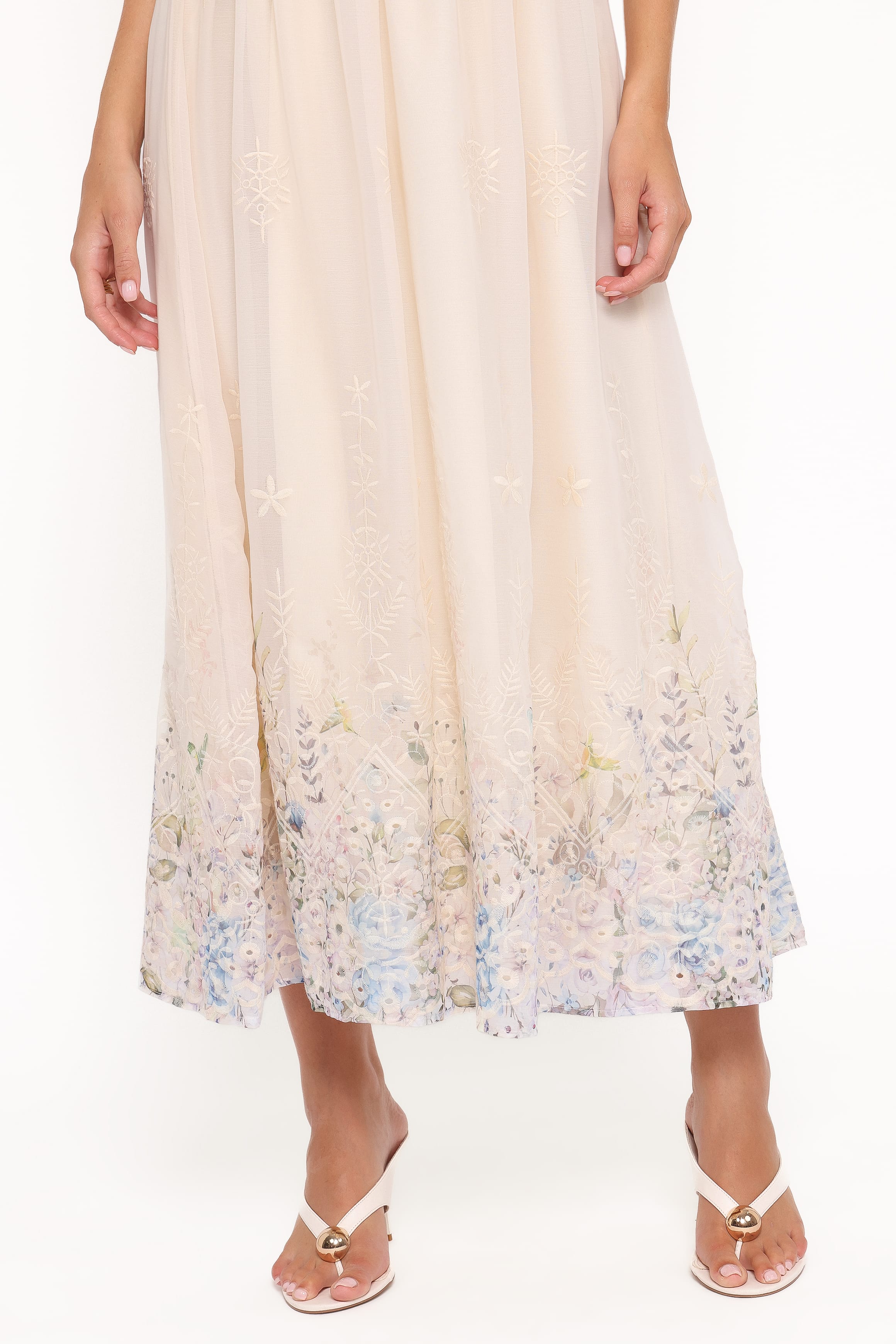 Beige dress with floral hem on a white background
