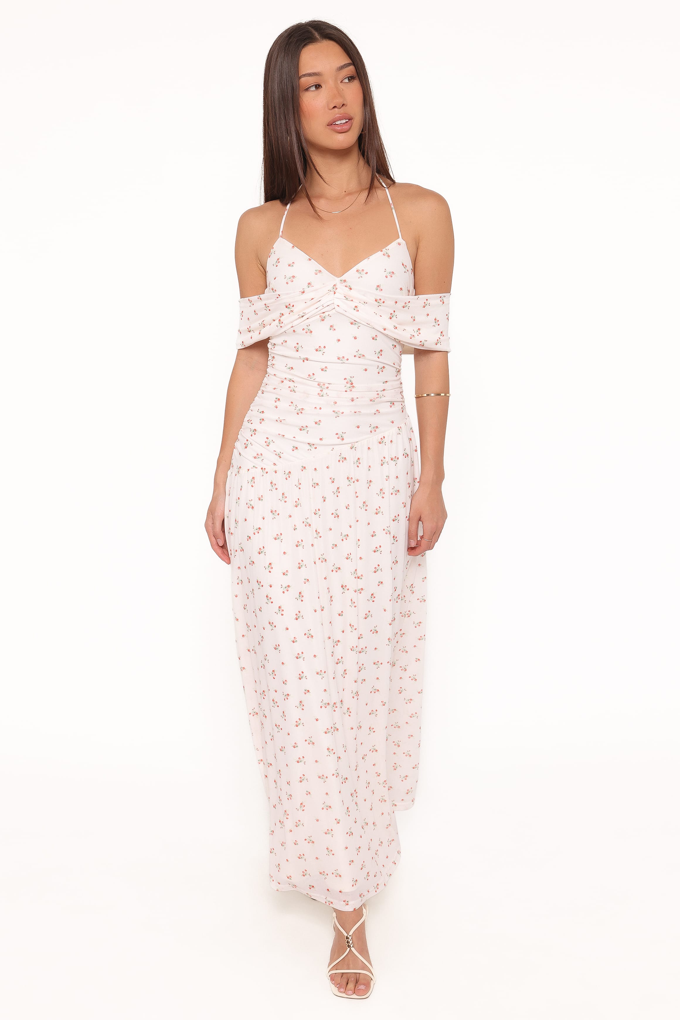 Woman wearing a white floral dress on a white background