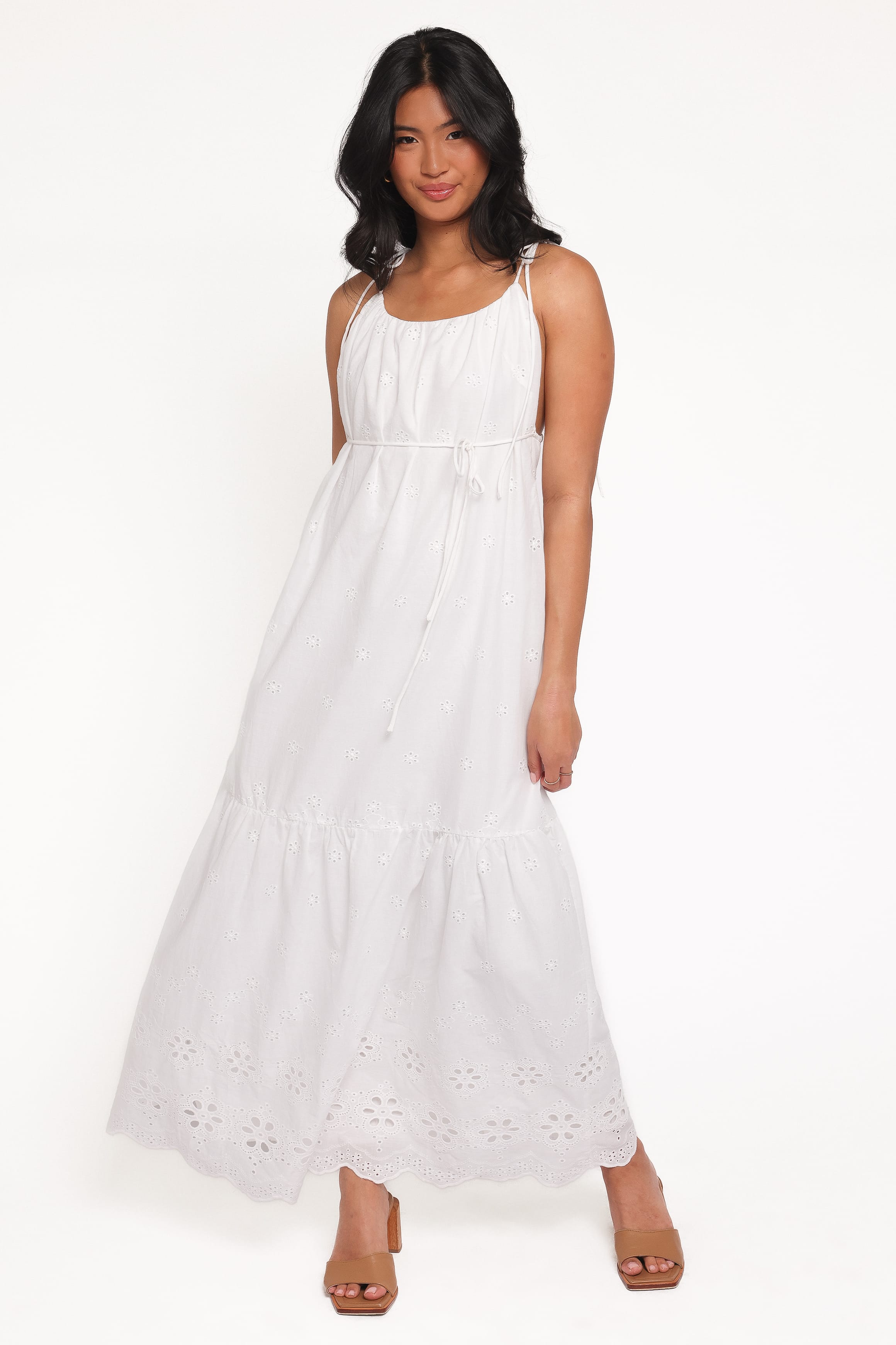 Woman wearing a white sleeveless dress on a white background